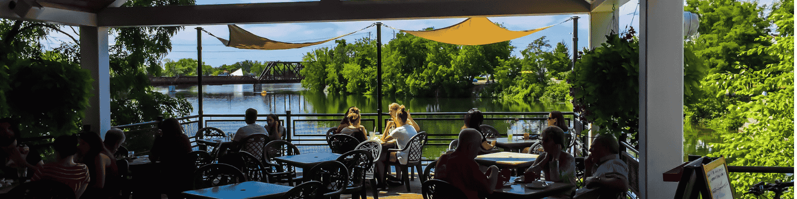 Customers sitting on the patio at the Silver Bean Cafe in Millennium Park - overlooking the water at Little Lake.